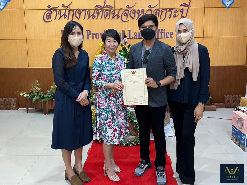 Walin with clients and a property document at the Krabi Provincial Land Office